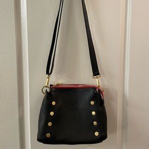 Bryant medium pebble leather Crossbody bag. Black with red interior and accent.